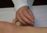 Doctor Cao adjusting Acupuncture needle at the East West College of Natural Medicine.