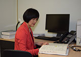 Doctor Cao working in her office at the East West College of Natural Medicine.